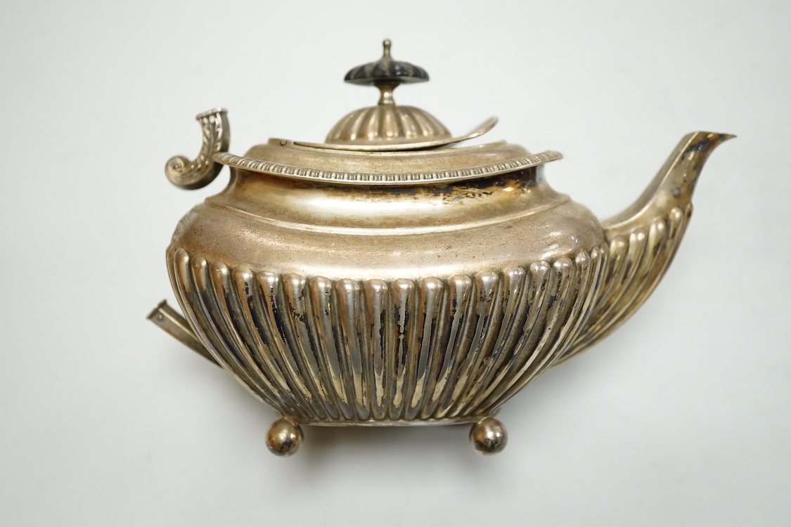 An early 20th century demi-fluted silver oval teapot, by James Dixon & Sons, Sheffield, 1903?, handle detached, together with a George III pierced silver oval salt, by Robert Hennell I, with glass liner(a.f.), gross weig